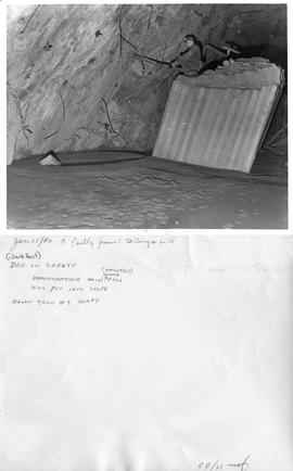 Jan 11/60 a partly poured tailings fill - (Jack Heit) Dad on safety demonstrating how fill was put into stope (tailings slime) below 4,000 #9 shaft - Mill hole in a stope - Jan. 11/60